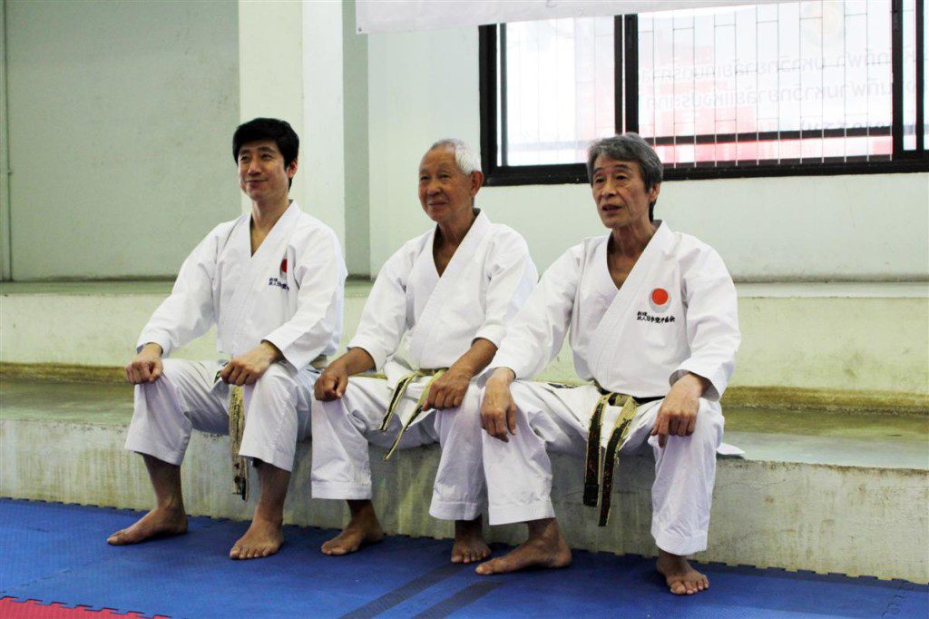 tetsuya naka sensei, sukimura sensei, Omura sensei sitting on small wall