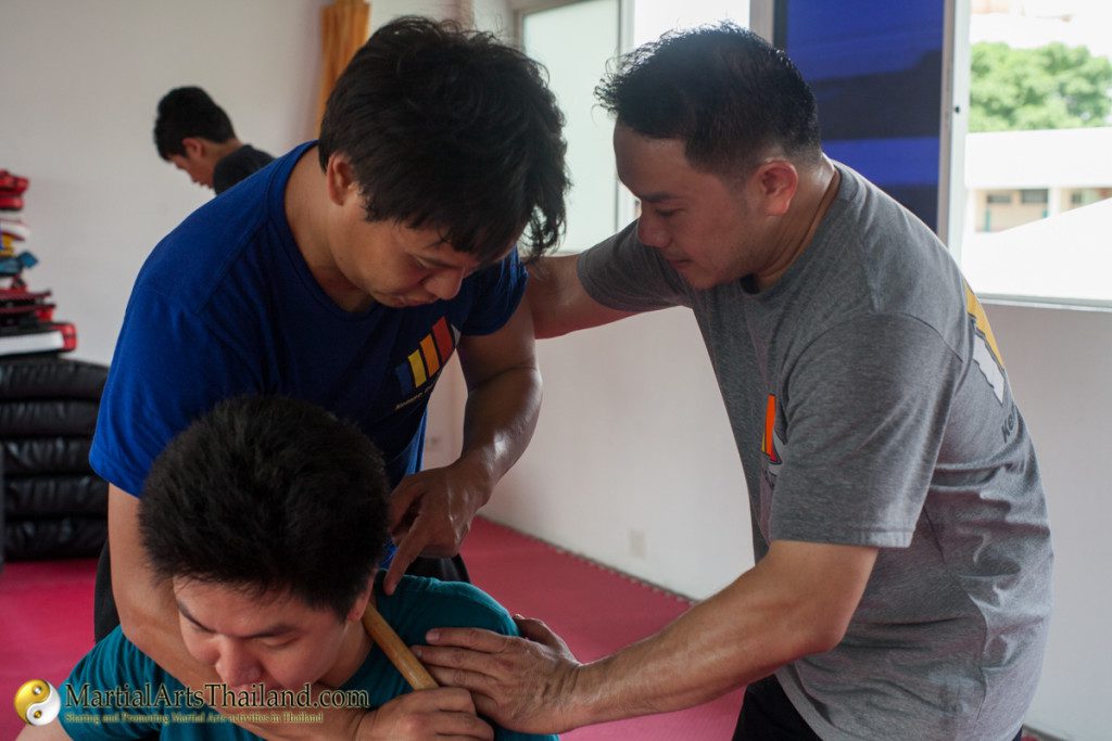 Bing Kempo combatives training class teaching rear choke with kali stick