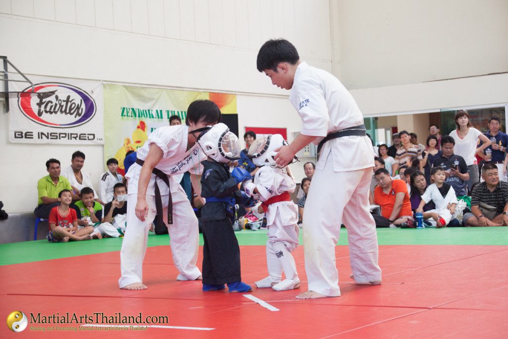 kids on mat with referee ready to fight