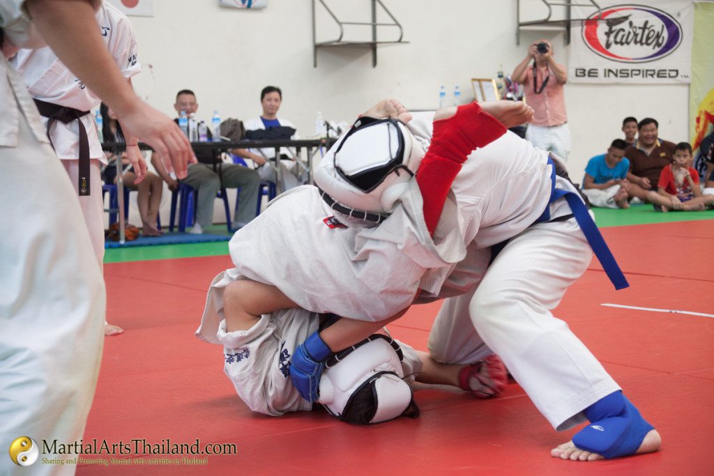 grounded fighter performing arm lock with his legs up