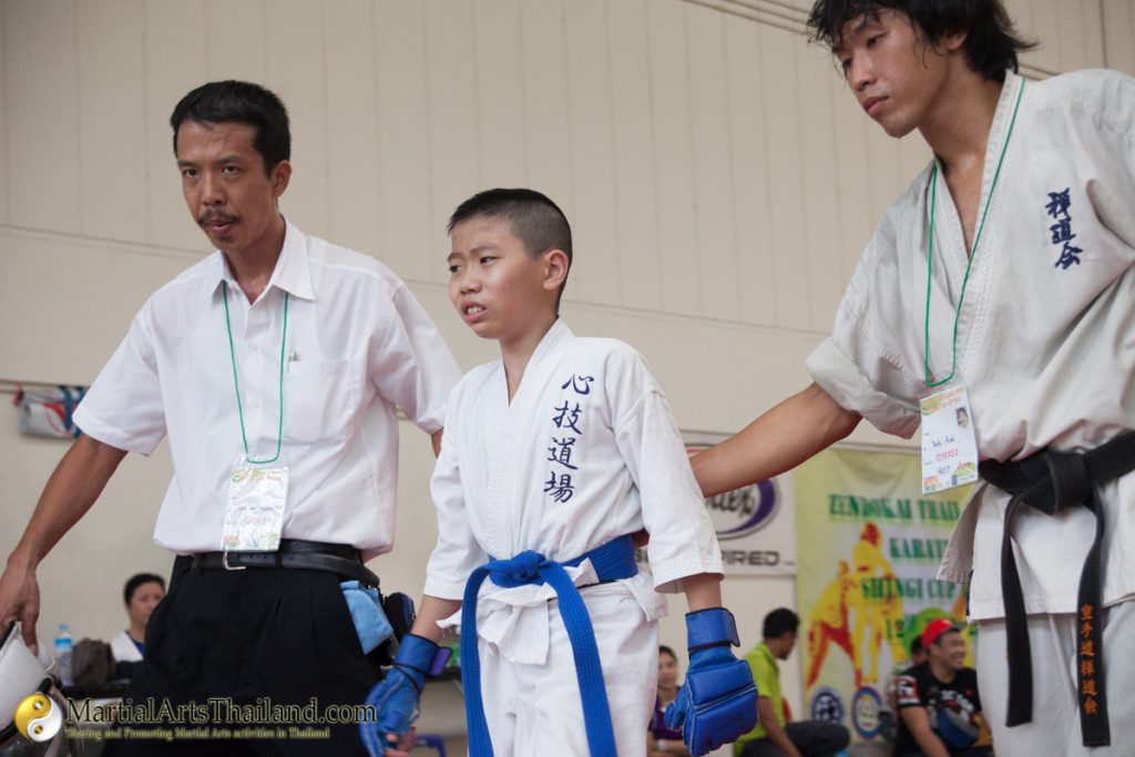 blue belt kid getting ready to enter mat for his fight