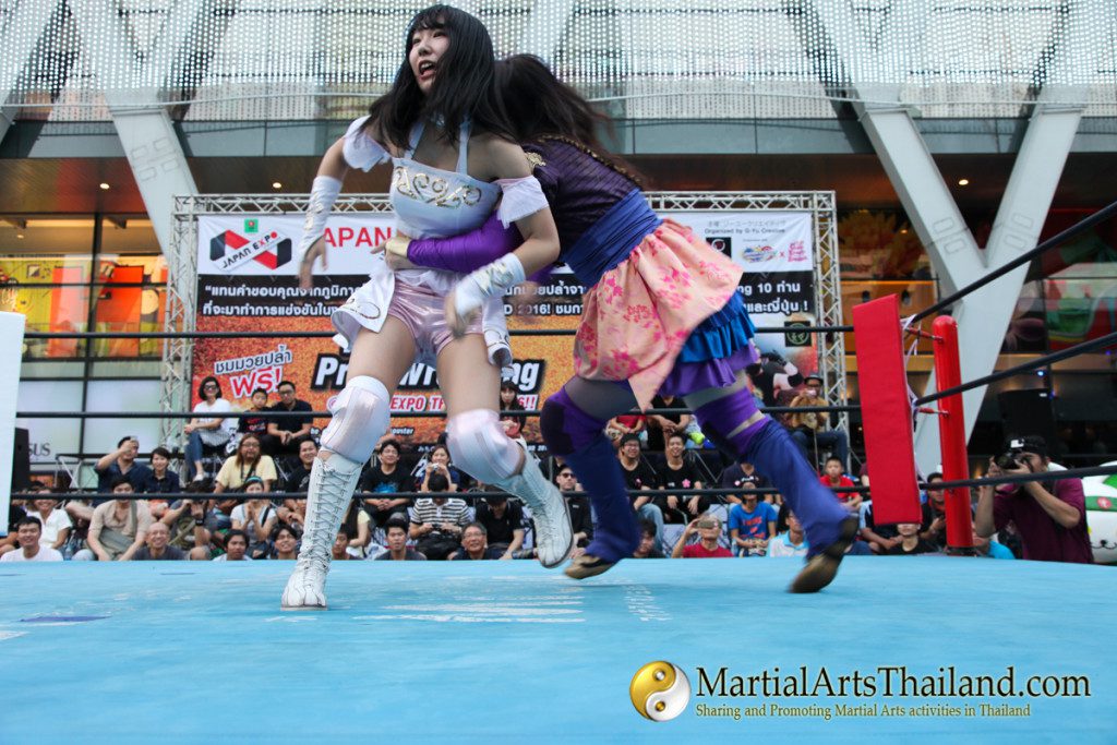 female fighter preparing to lift opponent