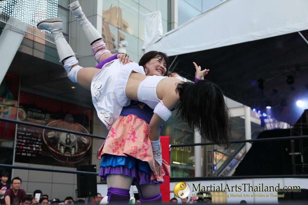flying female fighter landing on opponent at Pro-Wrestling Japan Expo 2016 Bangkok