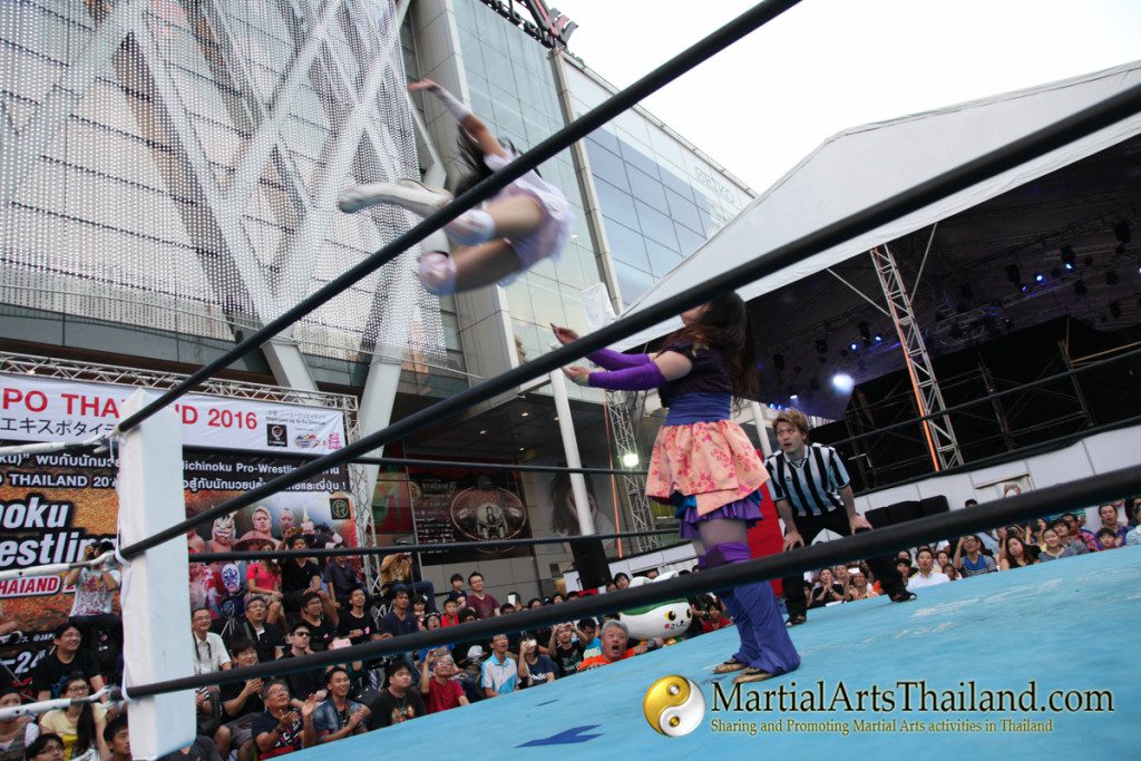 female fighter flying high to another fighter on ring at Pro-Wrestling Japan Expo 2016 Bangkok