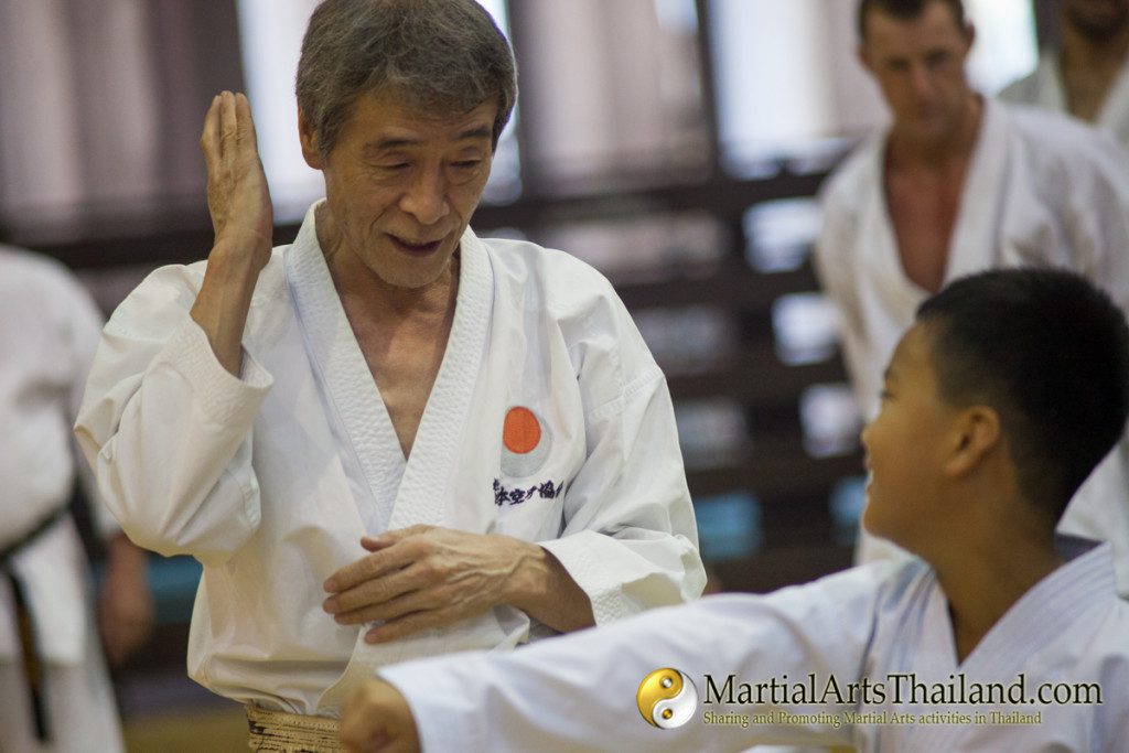omura sensei playing with kid during siam camp 2016