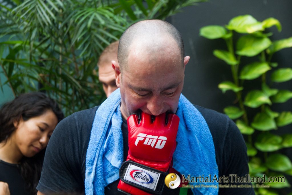 dominic fontanarosa with FMD MMA glove in his mouth  at Full Metal Dojo 10 To Live and Die in Bangkok