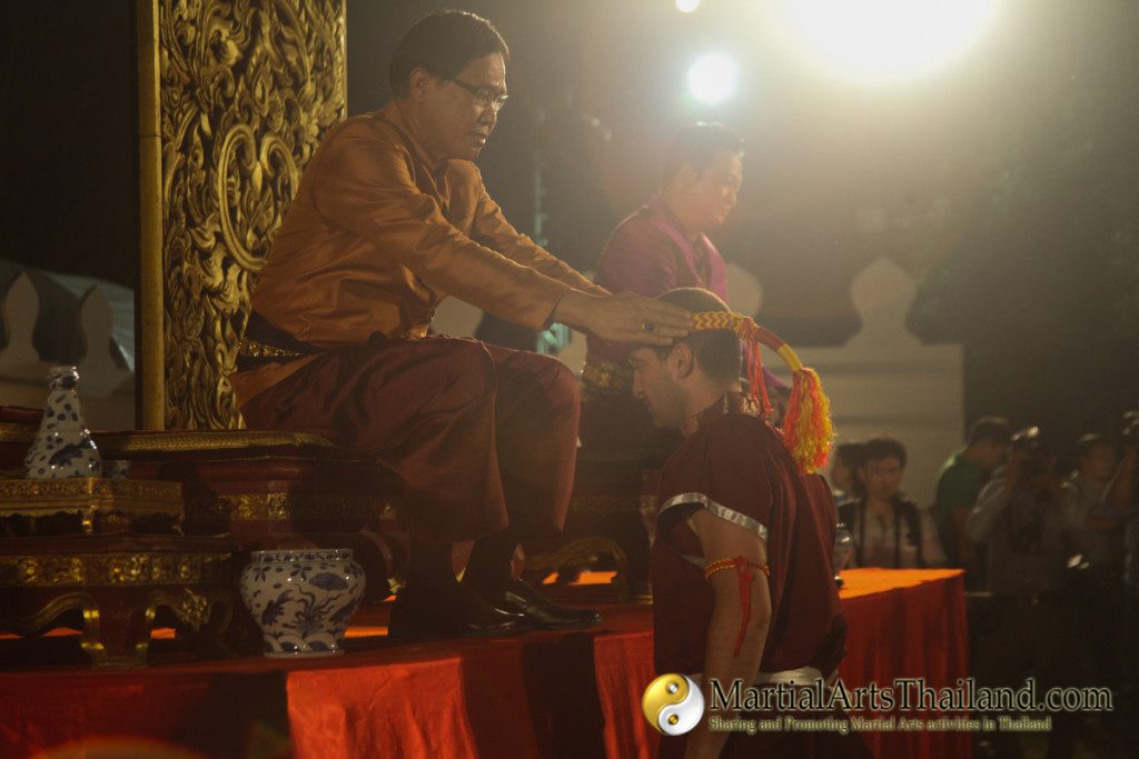 governor of Ayutthaya placing the mongkol on the head of a student
