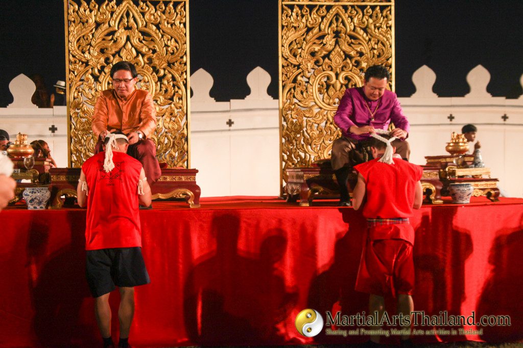 governor of ayutthaya placing mongkol on a student at the 12th Wai Kru Muay Thai Ceremony 2016