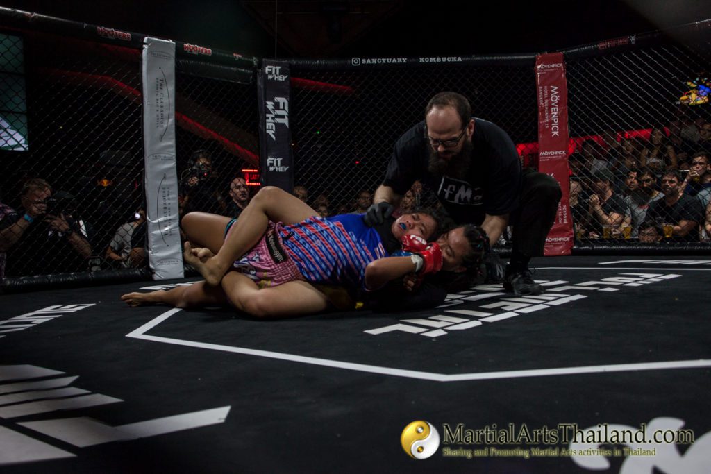 dana blouin checking on female fighters performing a rear naked choke at Full Metal Dojo 13 Concrete Jungle