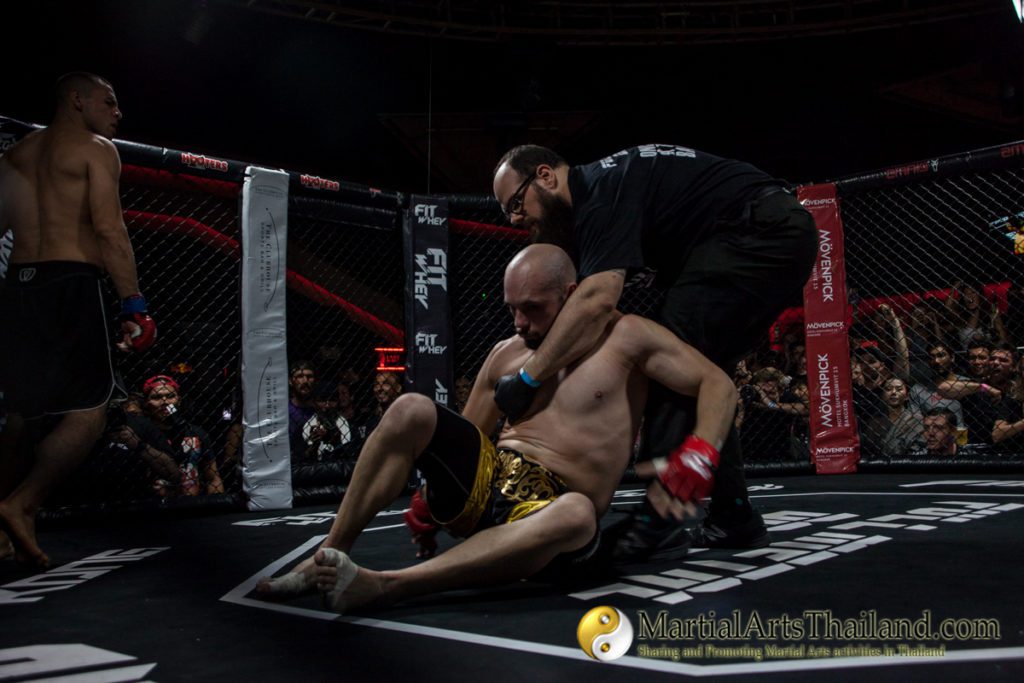 dana blouin helping fighter to get up after being ko by javier trujillo at Full Metal Dojo 13 Concrete Jungle