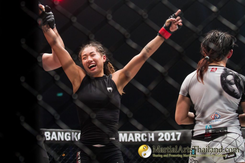 Angela Lee raising arms after being declared champion