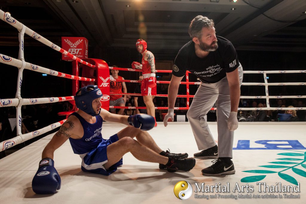 jon nutt check fighter on floor after koannouncer  on ring with fighter winner at Operation Smile Fight Night 2018
