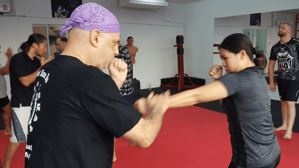 Girl practicing punch during class training at Core Combat Chaing Mai