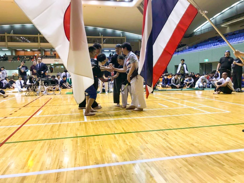 hand shake between Japan and Thai teams at competition Black Wing spochan sports chambara 