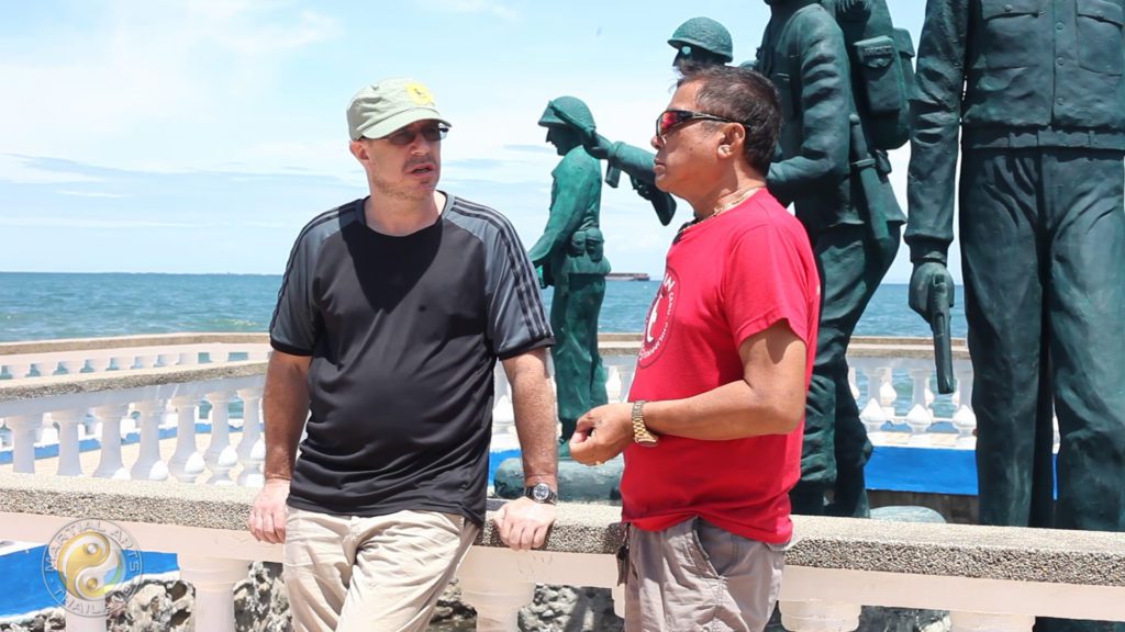 Alfredo Carin and Leigh Harris during interview at cebu beach with momument of US soldiers